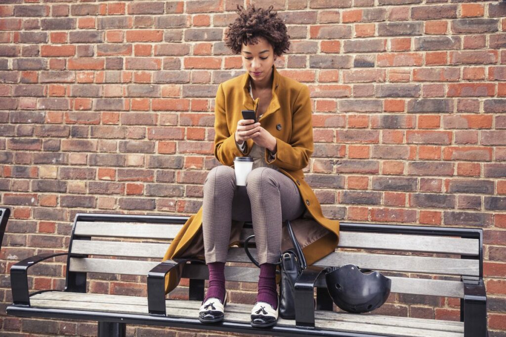 Woman on bench with Voys Freedom App